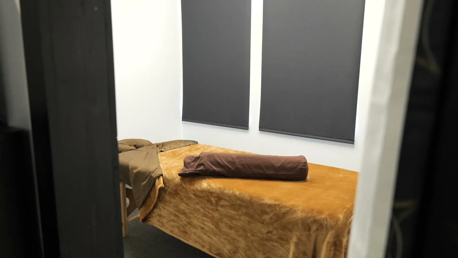 A treatment room with a massage table ready for a guest
