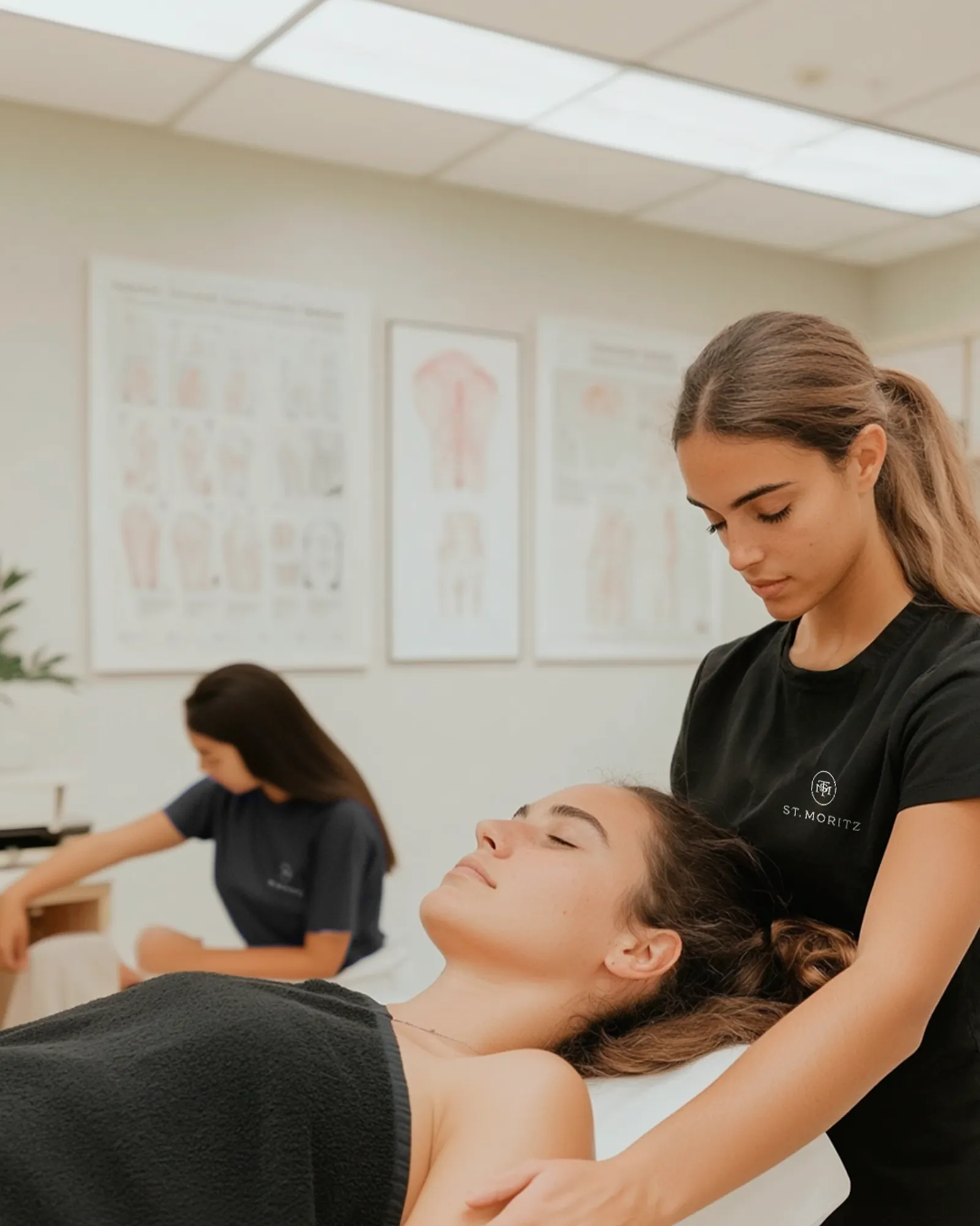 A St. Moritz student practicing massage technique on a classmate